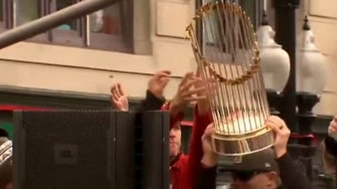Boston Red Sox fan hits World Series trophy with beer can