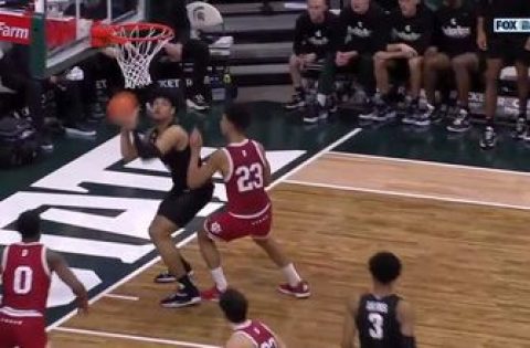 Michigan State’s Malik Hall makes an impressive shot from behind the backboard to beat the shot clock