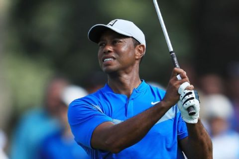 Tiger finishes round 6 shots behind lead at BMW