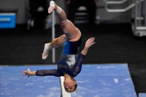 Michigan women win 1st gymnastics title over OU